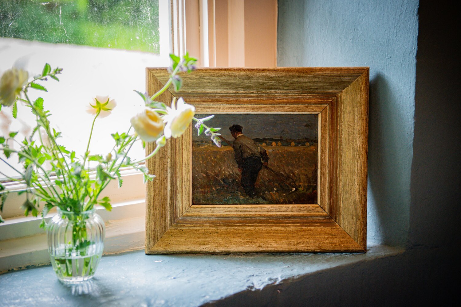 Impressionist artwork hung in an interior setting