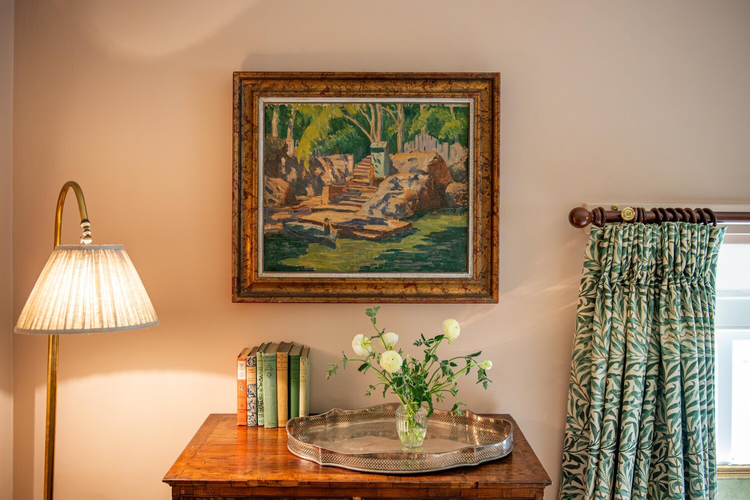 Impressionist artwork hung in an interior setting