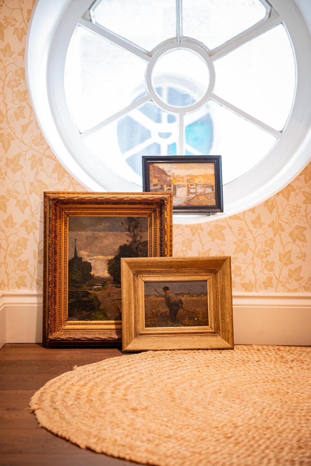 Impressionist artwork hung in an interior setting